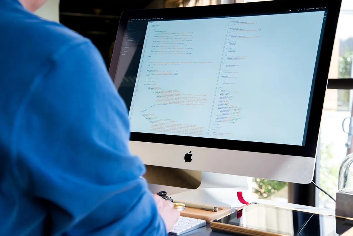 man, computer, screen, desktop, imac, apple products, desktop computer, workspace, workplace, working, technology, indoors, desk, office, information, display,